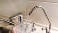 Water being poured into glass from kitchen tap. Concept. Close-up of tap water being poured into a glass in the kitchen Royalty Free Stock Photo