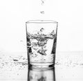 Water being poured into a glass. White background Royalty Free Stock Photo