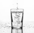 Water being poured into a glass. White background Royalty Free Stock Photo