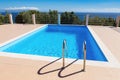 Water in blue swimming pool near sea in greece Royalty Free Stock Photo