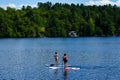 Water boarder enjoys summer day on Mirror Lake in Lake Placid, New York State Royalty Free Stock Photo