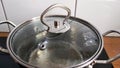 Water boils in a saucepan under the lid