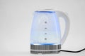 water boils in a transparent electric kettle on a white background. macro.