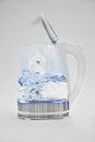 Water boils in a transparent open electric kettle on a white background. macro.