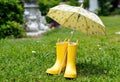 Yellow Rain Boots and Umbrella on Wet Grass Outdoor Play Ready Royalty Free Stock Photo