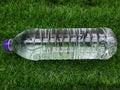 Water bottle on green grass as background Royalty Free Stock Photo