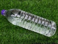 Water bottle on green grass as background Royalty Free Stock Photo