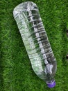 Water bottle on green grass as background Royalty Free Stock Photo