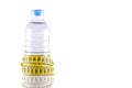 water bottle surrounded by yellow tapeline or measurement tape Royalty Free Stock Photo