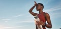 Water bottle, tired and black woman on break after running, exercise or cardio workout with low angle and mock up