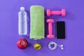 Water bottle, towel, measuring tape, dumbbells, apple, mobile phone and headphones Royalty Free Stock Photo