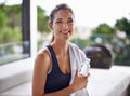 Water bottle, towel and portrait of fitness woman at gym for health, wellness or workout. Exercise, smile and happy Royalty Free Stock Photo