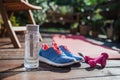 Water bottle, trainers and dumbbells outdoors on a terrace in summer. Royalty Free Stock Photo