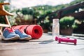 Water bottle, trainers and dumbbells outdoors on a terrace in summer. Royalty Free Stock Photo