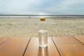 Water bottle on wooden floor on sea beach and blue sky background Royalty Free Stock Photo