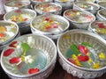 Water in bowl mixed with perfume and vivid flowers corolla for Songkran festival in Thailand Royalty Free Stock Photo