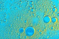 Water bubbles on blue and yellow background. Scientific image of