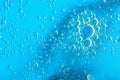 Water bubbles on blue and yellow background. Scientific image of cell membrane. Macro up of liquid substances. Abstract molecule a