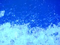 Water bubbling and frothing against deep blue background