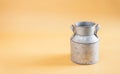 Water cans made of tin on yellow background Royalty Free Stock Photo