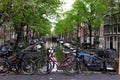 Water canal in Amsterdam with a bicycle wheel Royalty Free Stock Photo
