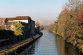 Water Canal channel and reflections of trees and buildings in Robbecoo sul Naviglio, Italy