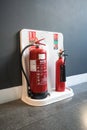 Water and Carbon Dioxide Fire Extinguishers at a fire station by a wall Royalty Free Stock Photo