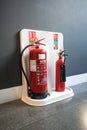 Water and Carbon Dioxide Fire Extinguishers at a fire station by a wall