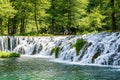 Man sitting by water cascade on river Pliva near city of Jajce in Bosnia and Herzegovina