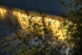 Water cascade on the Vltava river in Prague during early morning sun with vegetation in the foreground Royalty Free Stock Photo