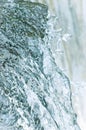 Water cascade waterfall streaming splashes background, large detailed vertical closeup, bright blue, sea green pastel colors Royalty Free Stock Photo