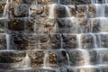 Water cascades over black rocks in tiered waterfall Royalty Free Stock Photo