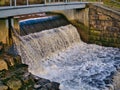 Water cascades over a water management weir on the River Whitendale in Lancashire, northern England. Royalty Free Stock Photo