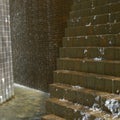 Water cascading down on bricks Royalty Free Stock Photo