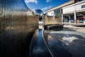 Water cascading down silver walled water feature in Millennium Square, Bristol, Somerset, UK