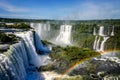 Water cascading over the Iguacu falls with rainbow in foreground Royalty Free Stock Photo