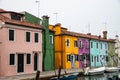 Features old multicolored houses, of Burano, Venice, Italy