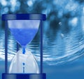 water clock on sea wave background close-up Royalty Free Stock Photo