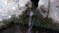 Water coming out of a natural stream