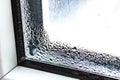 Water condensate drops on window glass.Drops of condensate and black mold on a substandard metal-plastic window.Concept: Royalty Free Stock Photo