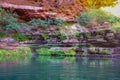 Water containing rock layers at circular pool in Dales Gorge Karijini National Park forming natural oasis