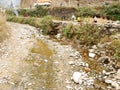 Water in creek canal and irrigation reservoir evaporated lost in drought dry season at countryside rural hill valley village in