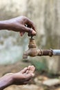 Water crisis is a serious threat to India and worldwide,a man holding his hand under the tap for water Royalty Free Stock Photo