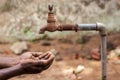Water crisis is a serious threat to India and worldwide,a man holding his hand under the tap for water Royalty Free Stock Photo