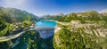 Water dam and reservoir lake aerial panoramic view in French Alps mountains generating hydroelectricity. Low CO2 footprint,