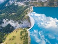 Water dam and reservoir lake in Swiss Alps to produce hydropower, hydroelectricity generation, renewable energy, aerial drone