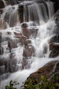 Water delicately falls over boulders in Connestee Falls in Pisgah Forest