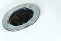 Small DOF. Damaged sewer hole with corrosion elements in a white bath, washbasin or shower. Water destroys everything. Concept on