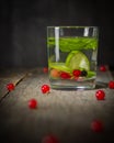 Water detox in a glass beaker. Fresh green mint and berries. A refreshing and healthy drink.