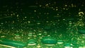 Macro green paint colored water surface with oil drops moving mixing in, abstract wallpaper background. Royalty Free Stock Photo